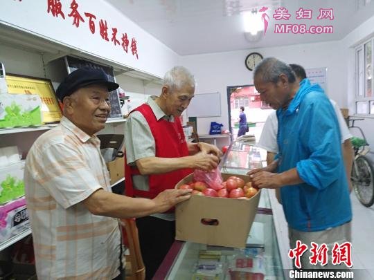 针对小区居民老人居多、出门购物不便的状况，老党员、志愿者每天义务去市场批发日常生活用品，回到小区平价卖给小区居民。图为红巾社区80多岁志愿者卖菜给小区居民。 赵桂华 摄